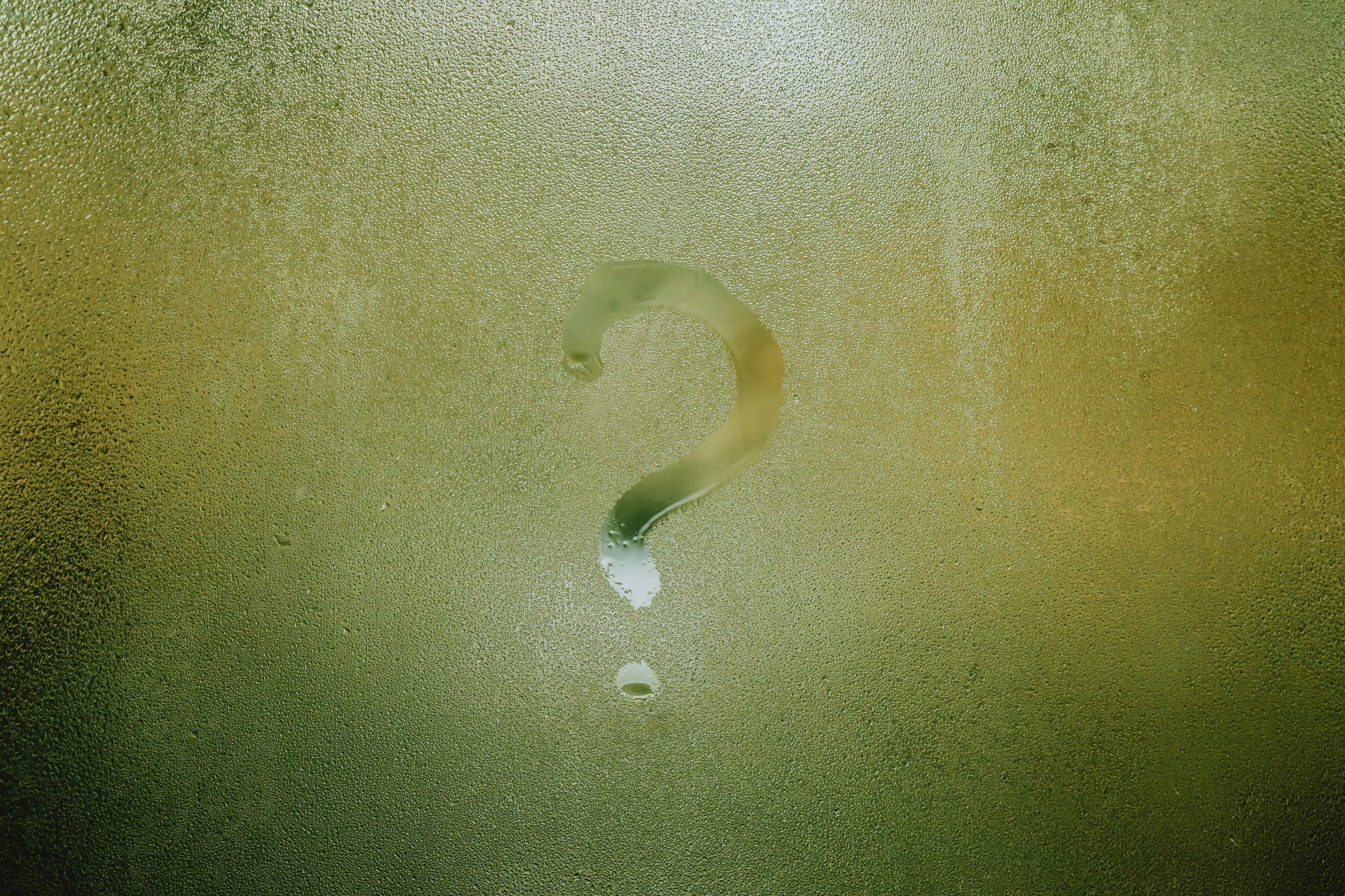 A steamy window with a question mark